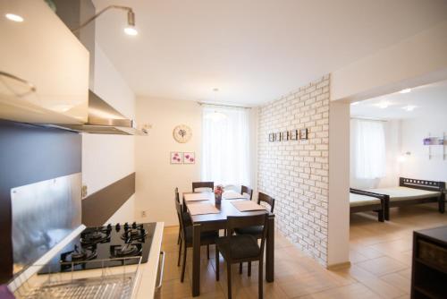 a kitchen and dining room with a table and a stove at Apartmány Lea in Liptovský Mikuláš