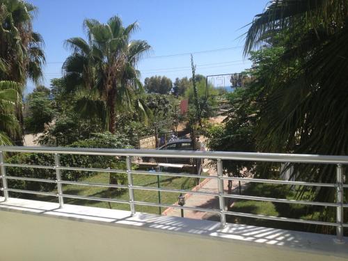 a view from the balcony of a house with palm trees at Hotel Simsek in Finike