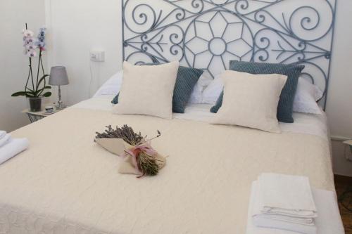 a bedroom with a white bed with a metal headboard at DOLCE VITA in Tempio Pausania