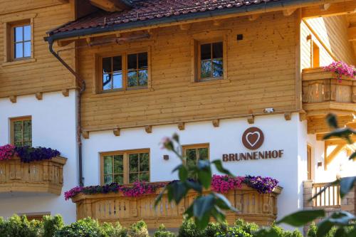 a building with flowers in front of it at Appartementhaus Brunnenhof in Wagrain