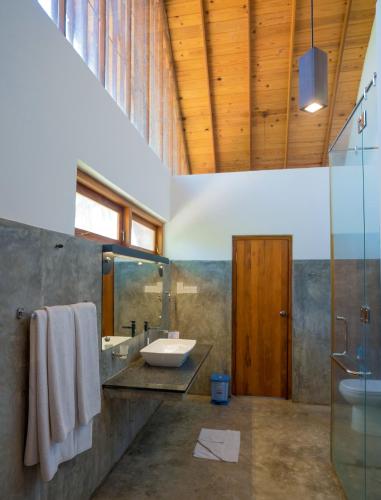 a large bathroom with a sink and a shower at Miracle Resorts & Villas in Polonnaruwa