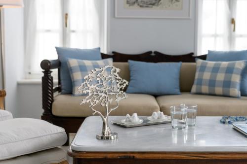 a living room with a couch and a table at Hydras Chromata in Hydra