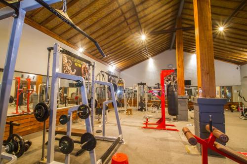 a gym with dumbbells and weights in a room at Uma Caming Villas & Gym in Tegalalang