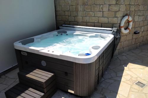 a large jacuzzi tub in a room with a stair at Villa HERMIONA in Kouklia