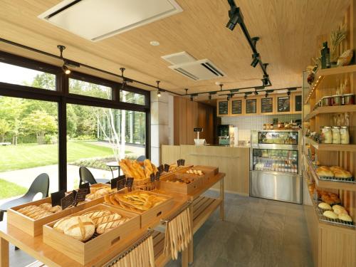 a kitchen with a table with lots of bread at Hakodate Onuma Tsuruga Resort EPUY- 30km from Hakodate Station in Hakodate