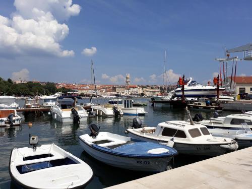 a group of boats docked in a harbor at Studio Apartments Maslinik in Krk