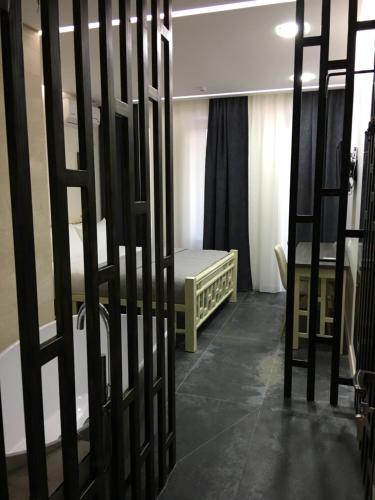 a room with a bed and a crib in it at Moonlight Hotel in Chişinău