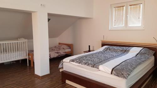 a bedroom with a large bed and a window at Villa BS Sarajevo in Sarajevo