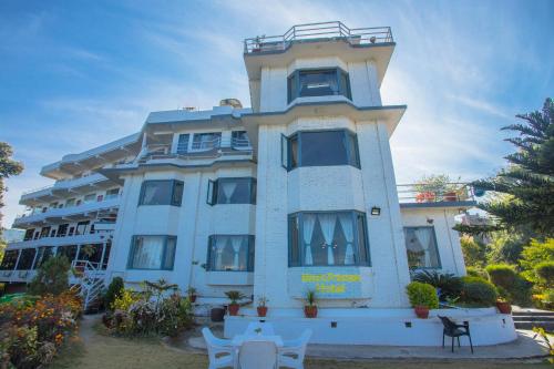 a large blue building with a lot of windows at Mount Princess Hotel in Dhulikhel
