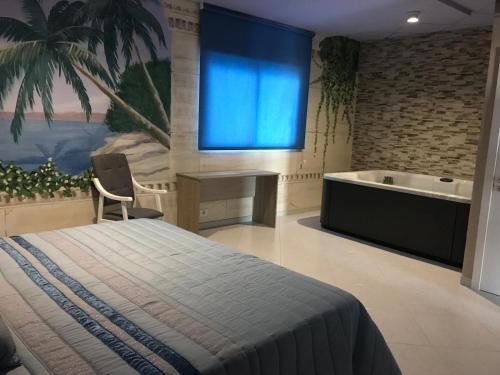 a bedroom with a bed and a bath tub at Hotel O Camiño in O Barco de Valdeorras