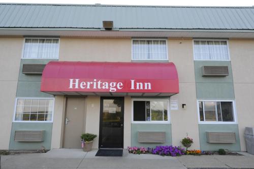 a store with a red awning on a building at Heritage Inn Mansfield in Mansfield