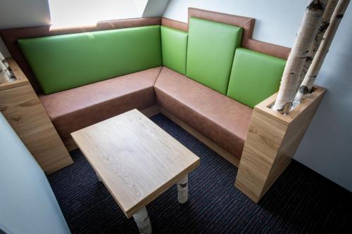 a small room with a couch and a table at Genussgasthof Willenshofer in Sankt Kathrein am Hauenstein