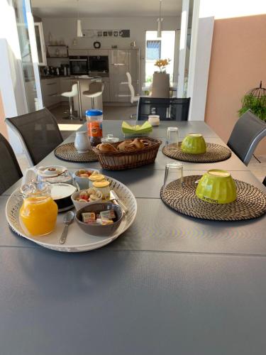 a table with two plates of food on it at Chambre d'hôtes dans Villa Diane in La Londe-les-Maures