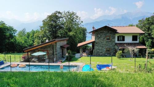 a house with a swimming pool in front of a house at Tenuta Pozzi in Colico