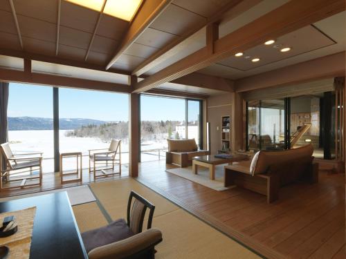 a living room with a view of the mountains at Akan Tsuruga Besso Hinanoza in Akankohan