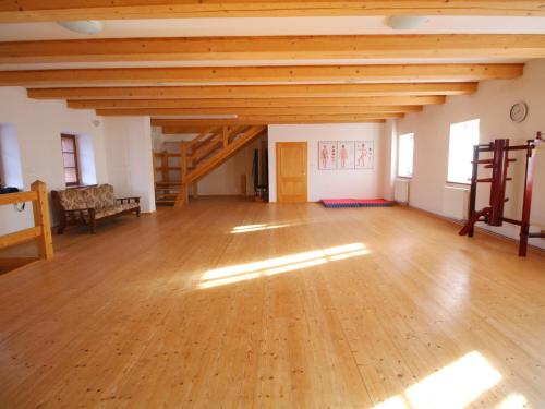 a large room with a wooden floor and wooden ceilings at Žabonosy Mlýn in Žabonosy