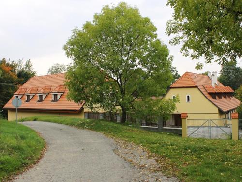 a road next to a house and a tree at Žabonosy Mlýn in Žabonosy