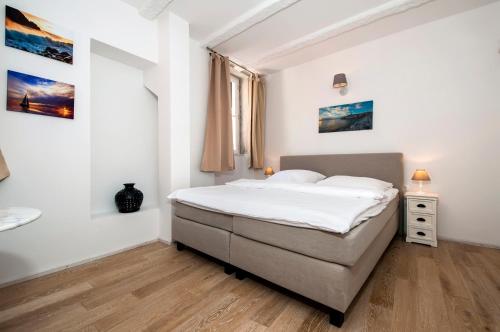 a bedroom with a bed in a white room at Casa Colloredo Free Parking in Rovinj