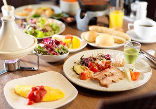a wooden table with plates of food on it at HOTEL＆SPA CENTURY MARINA HAKODATE in Hakodate