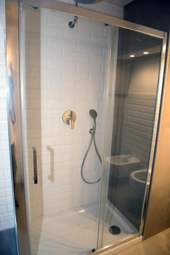 a shower with a glass door and a toilet at Don Alfredo in Taranto