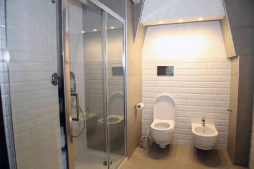 a bathroom with two toilets and a shower at Don Alfredo in Taranto