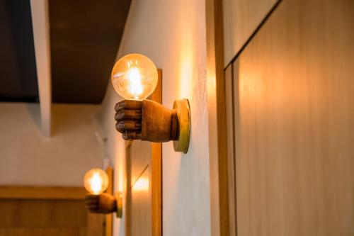a hand holding a light on a door at Hotel Lobby in Seville