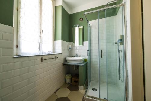 a bathroom with a sink and a glass shower at Guest House - Il Cedro Reale in Venaria Reale
