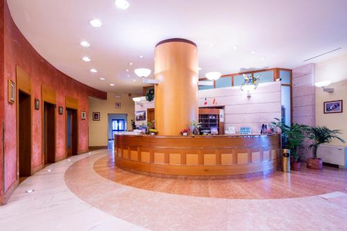 a lobby with a round counter in a building at Hotel Persico's in San Giovanni in Persiceto