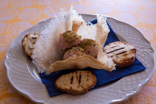 a plate of food with cookies on a table at Hotel Persico's in San Giovanni in Persiceto