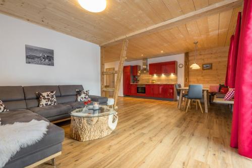 a living room with a couch and a table at Landhaus Panorama in Bad Hindelang
