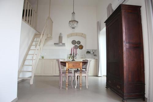 a kitchen with a table and chairs and a staircase at Don Alfredo in Taranto
