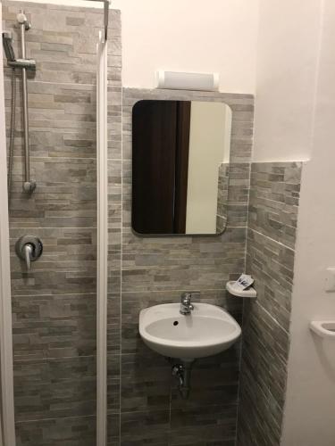 a bathroom with a sink and a mirror at Hotel Mirador in Aulla