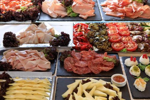 a display of different types of meats and cheese at Grand Hotel Palace Rome in Rome