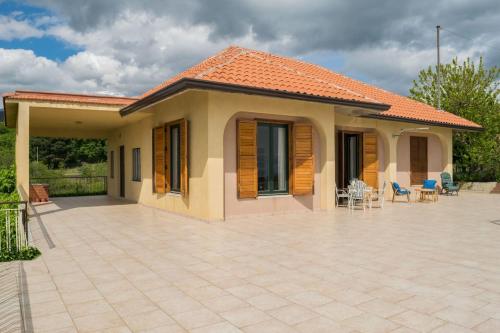 a small house with a patio in front of it at Le Vigne - Villa overlooking Etna in Adrano