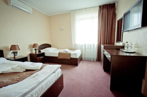 Katil atau katil-katil dalam bilik di Grand Sport Hotel