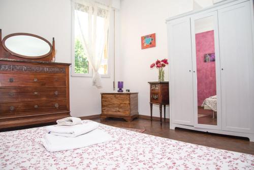 a bedroom with a bed with a mirror and a dresser at A Casa Fachin Room & Breakfast in Bologna