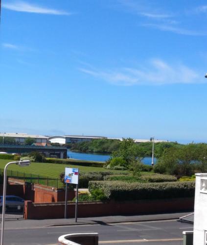 a view of a river with a bridge in the background at Bay Tree House Southport, United Kingdom in Southport