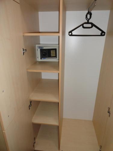 a small kitchen with a microwave in a closet at Rooms K in Maribor