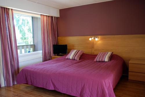 Ένα ή περισσότερα κρεβάτια σε δωμάτιο στο Revontuli Resort Rooms