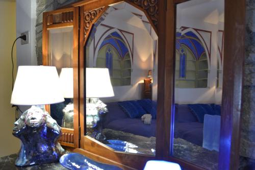 a bedroom with a couch and a mirror at ValdericArte in Lamoli Di Borgo Pace