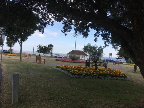 a park with a bunch of flowers in a flower bed at The Grosvenor in Clacton-on-Sea