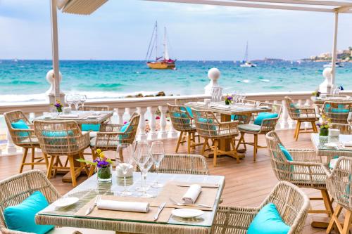 a restaurant on the beach with tables and chairs at Nixe Palace in Palma de Mallorca