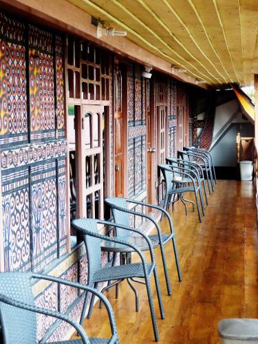 a row of tables and chairs in a restaurant at Toraja Torsina Hotel in Rantepao