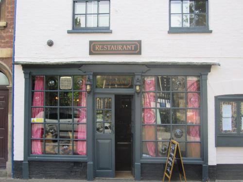 a store front with a sign above the door at The Old Vicarage Hotel & Restaurant in Bridgwater