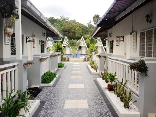 a courtyard of a house with a walkway at Nipah Guesthouse Pangkor in Pangkor