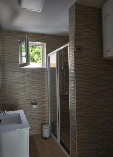a bathroom with a shower and a sink at Apartments Irina in Ičići