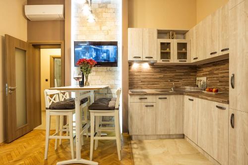 a kitchen with a table and chairs in a room at Sofia Place Hotel by HMG in Sofia