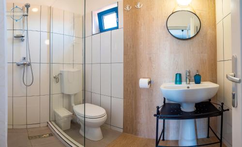 a bathroom with a sink and a toilet and a mirror at The Old Border in Vama Veche