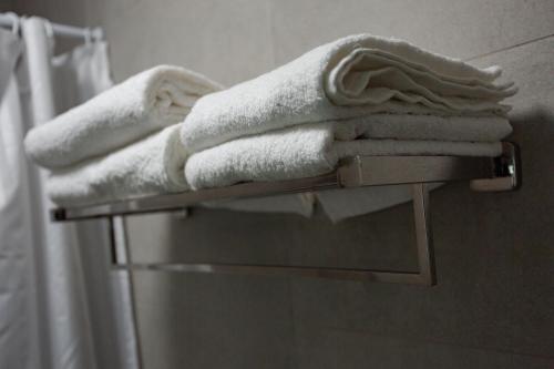 a pile of towels on a towel rack in a bathroom at Greendoor Arcadia in Odesa