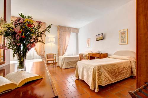 Postel nebo postele na pokoji v ubytování Hotel San Lino